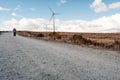 Wind turbine electricity generator in an open field, renewable energy concept. Source of green, clean power. Warm sunny day Royalty Free Stock Photo