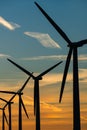 Wind turbine energy generaters on wind farm at sunset Royalty Free Stock Photo