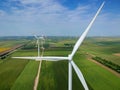 Wind Turbine Farm In Green Field - Green Energy