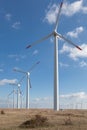 Wind turbine farm over the blue clouded sky Royalty Free Stock Photo