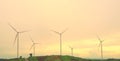 Wind turbine farm with power line and power plant during beautiful sunset, Alternative green energy for protection of nature