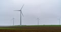 Wind turbine farm with single turbine focus of shot Royalty Free Stock Photo