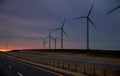 Wind energy blows into West Texas wind turbine farms in the colorful sunset showing renewable energy works Royalty Free Stock Photo