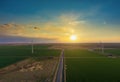 Wind energy blows into West Texas wind turbine farms in the colorful sunset showing renewable energy works Royalty Free Stock Photo