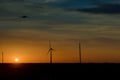 Wind energy blows into West Texas wind turbine farms in the colorful sunset showing renewable energy works Royalty Free Stock Photo