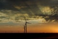 Wind energy blows into West Texas wind turbine farms in the colorful sunset showing renewable energy works Royalty Free Stock Photo