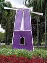 purple bamboo woven wind turbine tower among flower gardens in public park Royalty Free Stock Photo