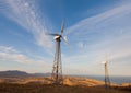 Wind turbine generating electricity in mountains at sunset Royalty Free Stock Photo