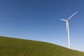 Wind Turbine on a grass field with a clear blue sky Royalty Free Stock Photo