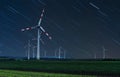 Wind turbine on green fields at night. Natural wind power plants and sustainable eco-friendly energy Royalty Free Stock Photo