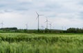 Wind turbine on green fields in summertime. Natural wind power plants and sustainable eco-friendly energy resource Royalty Free Stock Photo