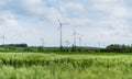 Wind turbine on green fields in summertime. Natural wind power plants and sustainable eco-friendly energy resource Royalty Free Stock Photo