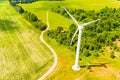 Wind turbine near green forest, aerial landscape. Producing energy in environmentally friendly way Royalty Free Stock Photo