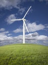 Wind Turbine Over Grass Field, Sky and Clouds Royalty Free Stock Photo