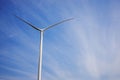 Wind turbine producing alternative energy on the background of blue sky. Royalty Free Stock Photo