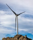 Wind turbine, renewable energy on a rocky hill Royalty Free Stock Photo