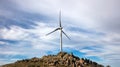 Wind turbine, renewable energy on a rocky hill Royalty Free Stock Photo