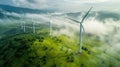 Wind turbine renewable energy windfarm with windmills aerial view with fog in green field