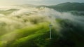 Wind turbine renewable energy windfarm with windmills aerial view with fog in green field