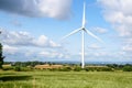 Wind turbine in rolling rural landscape in summer Royalty Free Stock Photo