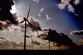 Wind turbine running at the edge of a country road Royalty Free Stock Photo