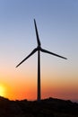 Pitch black silhouette of a wind turbine