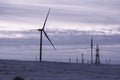 Wind turbine on snowy field at sunrise. Alternative energy sources. Eco-friendly electricity. Alternative energy winter