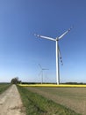 Wind turbine on spring day in Poland in rapeseed field Royalty Free Stock Photo