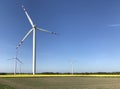 Wind turbine on spring day in Poland in rapeseed field Royalty Free Stock Photo