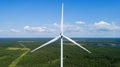 Wind turbine in summer forest, close up. Colorful aerial landscape. Alternative energy concept. Royalty Free Stock Photo