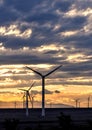 Wind turbine at sunset with beautiful clouds Royalty Free Stock Photo