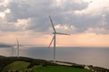 Wind turbine at sunset, on a hill with sea view. Royalty Free Stock Photo