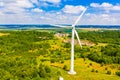 Wind turbine surrounded by green forest. Amazing landscape. Summer time. Alternative energy concept Royalty Free Stock Photo