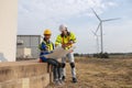 Wind turbine technician checking and maintenance at turbine station. Man engineer working at energy wind generator. clean energy