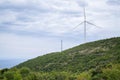 Wind turbine on the top of the mountatin with sea in background Royalty Free Stock Photo