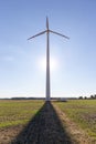 Wind turbine under blue sky at sunset, renewable energy concept photo Royalty Free Stock Photo