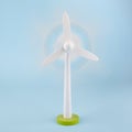 Wind turbine wooden toy or light blue background, eco concept