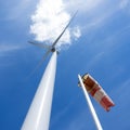 Wind turbine and windbag and white cloudagainst blue sky Royalty Free Stock Photo