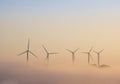 Wind turbines above the clouds at sunset Royalty Free Stock Photo