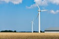 Wind turbines agricultural barn in a  wheat field Royalty Free Stock Photo