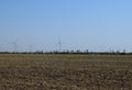 Wind turbines and agricultural field. Energy production, clean and renewable energy Royalty Free Stock Photo