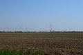 Wind turbines and agricultural field. Energy production, clean and renewable energy Royalty Free Stock Photo