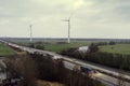 Wind turbines along highway Royalty Free Stock Photo