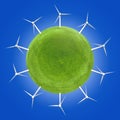 Wind turbines around a green planet symbolizing clean energies. Royalty Free Stock Photo