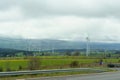 Wind turbines on the background of the field, mountains and clouds Royalty Free Stock Photo