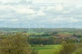Wind turbines on the background of the field, mountains and clouds Royalty Free Stock Photo