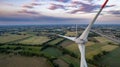 Wind turbines on beautiful sunny summer purple autumn rural agraric landscape. Green ecological power energy generation Royalty Free Stock Photo