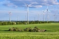 Wind turbines behind a green corn field Royalty Free Stock Photo