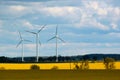 Wind turbines in a blooming yellow rape fields, Poland Royalty Free Stock Photo