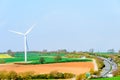 Wind Turbines and Blue Sky with Clouds over UK fields Royalty Free Stock Photo